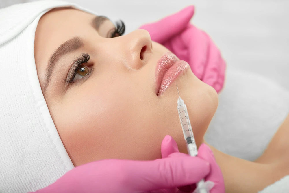young woman reclined for facial cosmetic filler injection