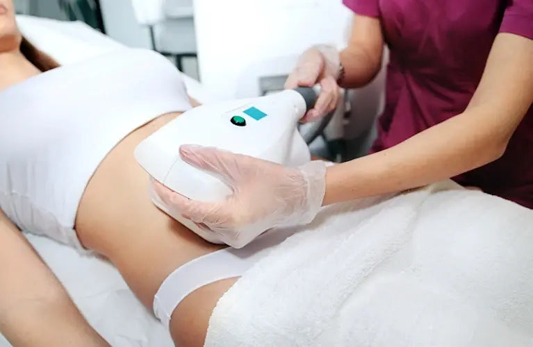 a procedure similar to CoolSculpting being  used on the abdomen of a woman